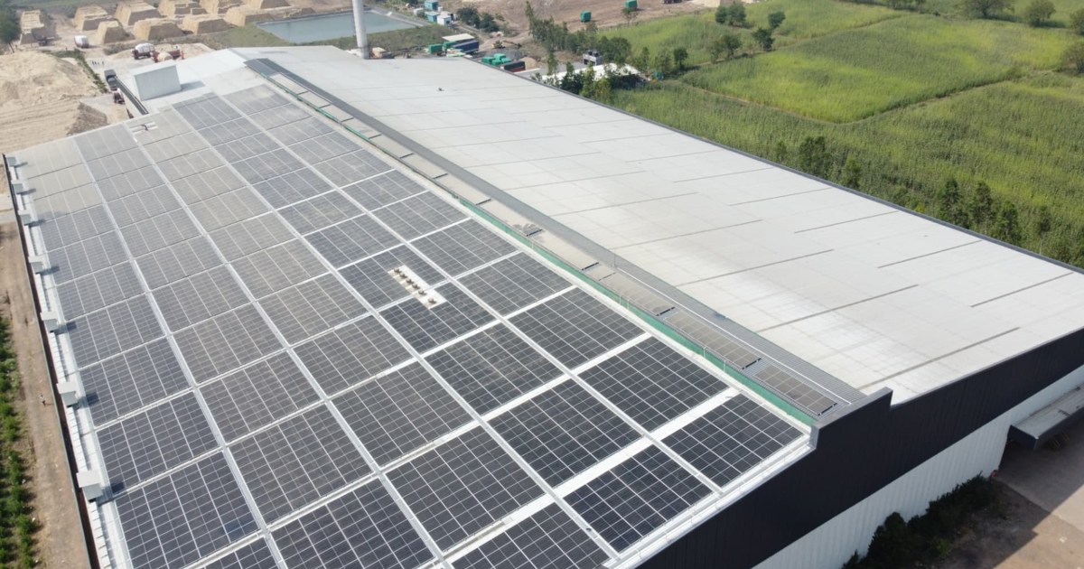 Photovoltaic panels across an industrial rooftop